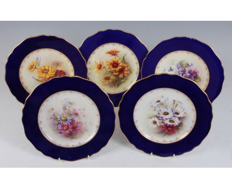 *Five Royal Worcester cabinet plates, each painted to the centre with flowers within wide cobalt blue border heightened in gi