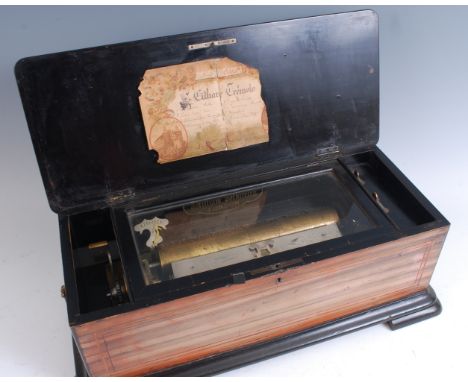 A late 19th century Swiss music box, the rosewood inlaid case decorated with musical instruments, the 10½" cylinder playing e