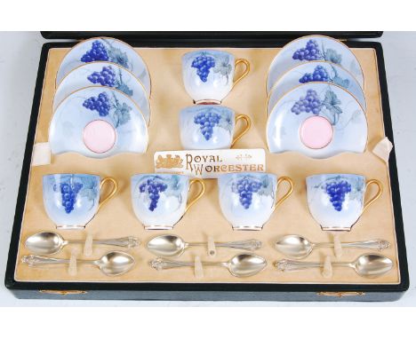 *A cased set of six Royal Worcester coffee cups and saucers, each piece on a light blue ground decorated with blueberries and