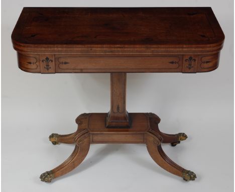 A Regency mahogany and ebony strung card table, the D-shaped fold-over top revealing a baize lined playing surface, on square