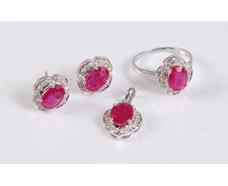 A 9ct ruby and diamond suite, the ring set with an oval ruby in a four claw mount, surrounded by small round diamonds, with p