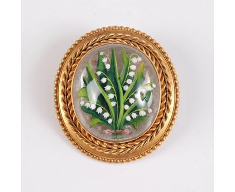 A late 19th century rock crystal painted brooch, the oval rock crystal cabochon painted with lilly of the valley, in a collet