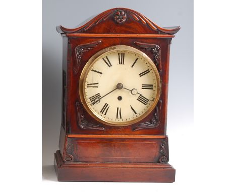 A Victorian mahogany bracket clock, having a serpentine top, white enamel dial, single winding hole for a wire-driven eight d
