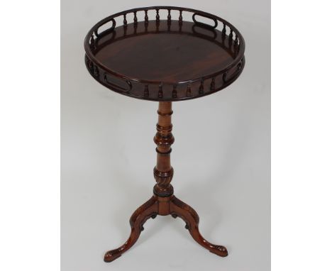 *A Georgian style mahogany pedestal tripod table, the associated circular tilt-top with turned spindle gallery, on further tu