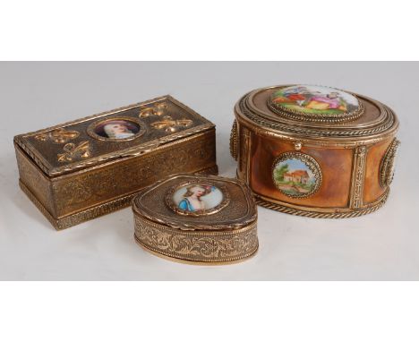 A circa 1900 continental gilt metal dressing table box, the hinged cover decorated with fleur de lis flanking porcelain inset