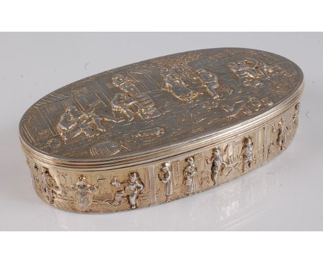 A late 19th century Hanau silver gilt table snuff-box, of oval form, the hinged cover repousee decorated with musicians and m