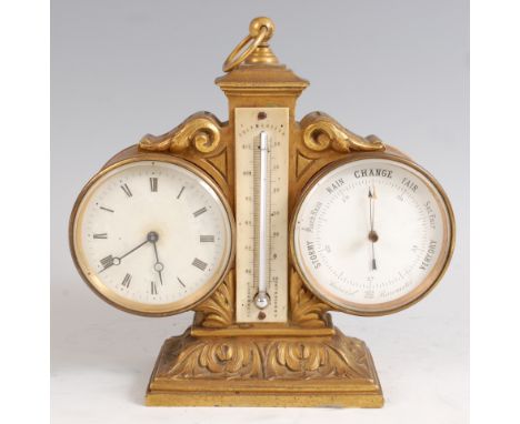 A circa 1900 gilt metal combination clock barometer and thermometer, having a centre ring carry handle, the barometer dial wi