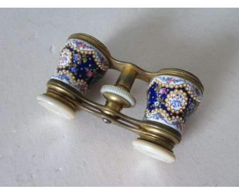 A fine quality pair of Opera Glasses, with decorative porcelain mounted with mother-of-pearl trim, contained within leather c