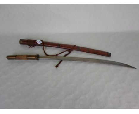 An early 20 mid-20th century Burmese short sword, having brass handle, mounted to a wooden and brass bound scabbard, the blad