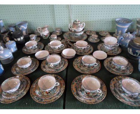 An extensive 20th century Chinese tea service, comprising: trios, soup bowls, coffee cans, plates and other items, decorated 