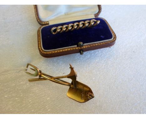 A 9ct gold bar brooch of rope twist form in fitted case, together with a further brooch modelled as gold mining tools, stampe