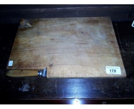 An oak cheese board and knife, featuring a mouse in the manner of Mouseman, 33cm x 22cm.