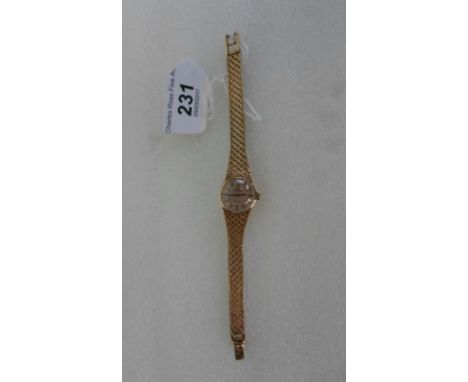 A lady's 9ct gold cased Omega wristwatch, the champagne dial bearing baton numerals, to a 9ct gold bracelet.   Condition Repo