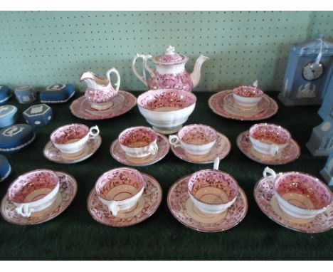 A Victorian pink lustre tea service, a nine place setting, comprising: teapot, cups & saucers, large open bowl, milk jug and 