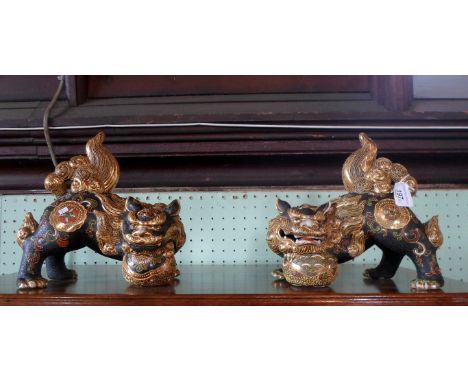 A pair of 20th century Chinese Do of Fo, each with painted enamel relief decoration and gilt finish, 22cm x 23cm.