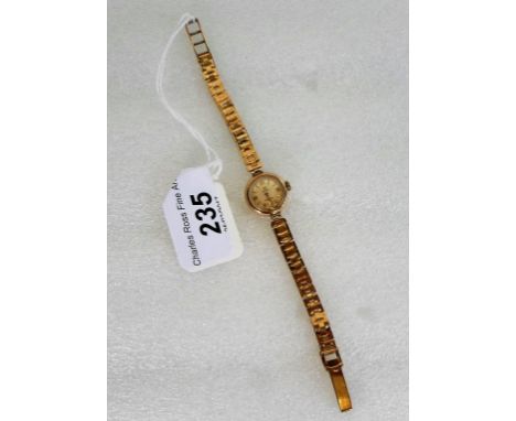 A lady's 9ct gold cased Cymaflex wristwatch, the champagne dial bearing baton numerals, to a 9ct gold snake link bracelet.   