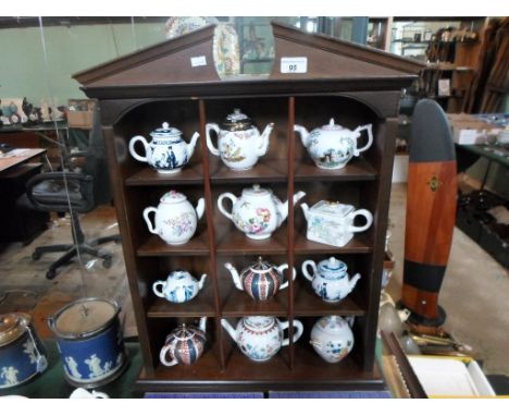 A collection of twelve porcelain teapots, produced by the Victoria & Albert Museum, to commemorate classic historical example