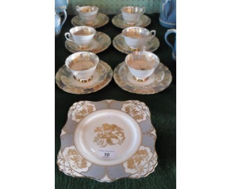 A Tuscan bone china part-tea service, comprising: six trios and a sandwich plate, having gilt decoration on an ivory ground. 