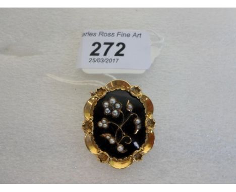 An early Victorian mourning brooch, oval shaped with black enamel, seed pearl and rose diamond floral centre and glazed hair 