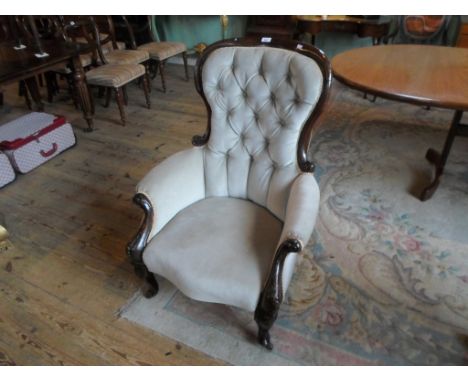 A mahogany upholstered button back fireside chair, on front cabriole supports, 76cm wide.