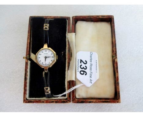 A lady's 9ct gold cased Buren wristwatch of octagonal form, the enamel dial bearing Arabic numerals, to a black leather strap