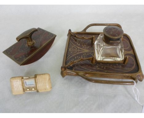 An early 20th century oak brass mounted and inlaid desk set of Art Nouveau form, comprising: stand, glass inkwell and blotter