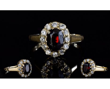 9ct Gold Set Diamond and Ruby Cluster Ring. Flowerhead Setting, The Central Ruby Surrounded by 12 Small Diamonds. Fully Hallm