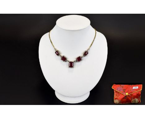 African Ruby And White Topaz Necklace Elegant necklace set with five rectangular step cut rubies, each surrounded by small fa