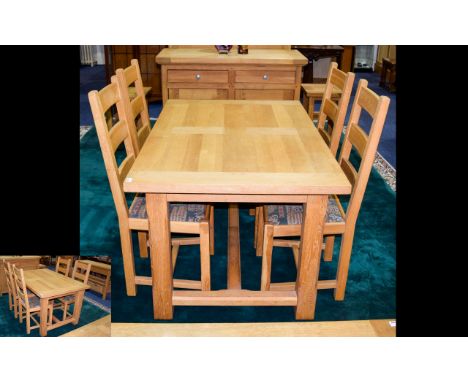 A Solid Oak Dining Suite Contemporary dining suite comprising extending table and four chairs of plain form. Chairs upholster