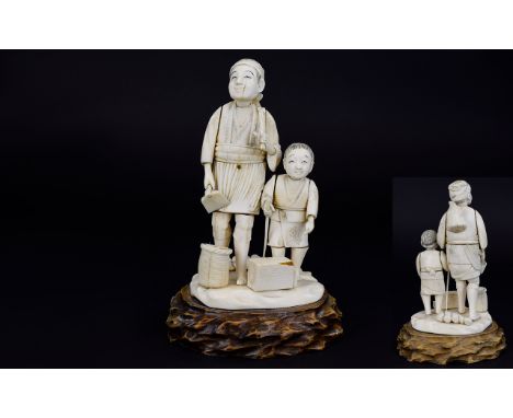 Japanese Late 19th / Early 20th Century Carved Ivory Figure Group of Father and Son Woodcutter with Baskets and Tools, Raised