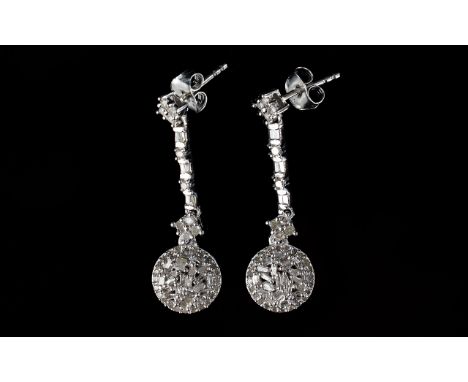 Pair of Diamond Cluster Drop Earrings, .75ct round clusters of baguette cut diamonds suspended from strands of baguette and r