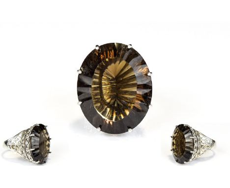 A Ladies large And Unusual Brazilian Smoky Quartz And Silver Statement Ring 50ct oval solitaire in smoky quartz with raised s