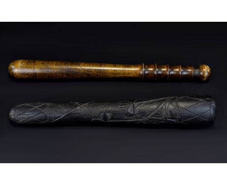A Pair Of Carved Wood Truncheons/Cosh Two items in total to include turned wood truncheon and Irish Carved Bog Oak cosh with 