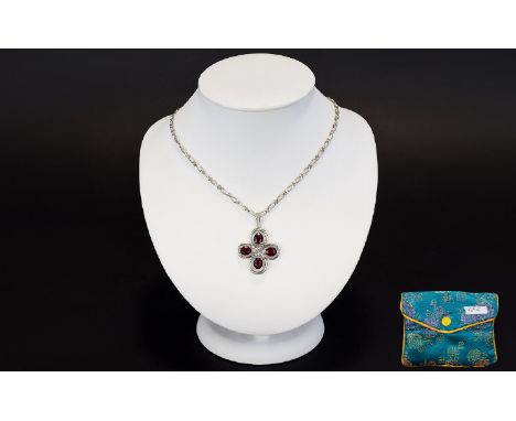 A Silver Ruby And Diamond Pendant Necklace Attractive long chain with quatrefoil ruby pendant comprising four faceted stones 