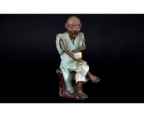 A Seated Chinese Man Reading a Scroll. 