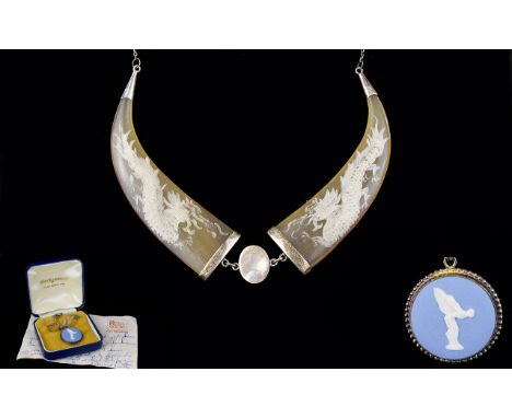 Oriental Silver And Horn Necklace Statement necklace comprising two polished horn section etched with rampant dragon design. 