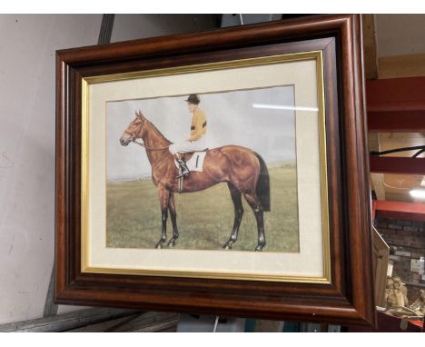 A FRAMED PRINT OF A JOCKEY ON A RACEHORSE (ARKLE?) 