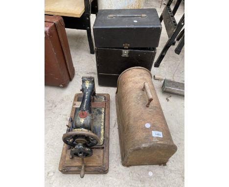 A VINTAGE CASED PROJECTOR AND A VINTAGE SINGER SEWING MACHINE WITH WOODEN CARRY CASE 