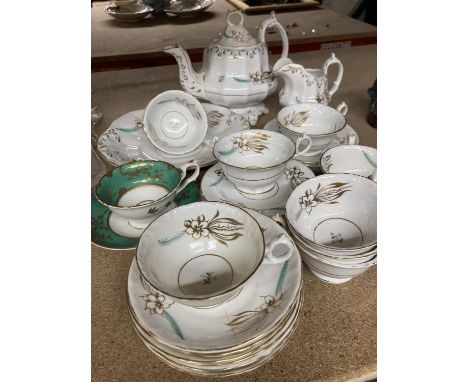 A FLORAL GILT AND GREEN DECORATED TEASET TO INCLUDE CUPS, SAUCERS, PLATES, A TEAPOT, CREAM JUG, SUGAR BOWL, ETC 