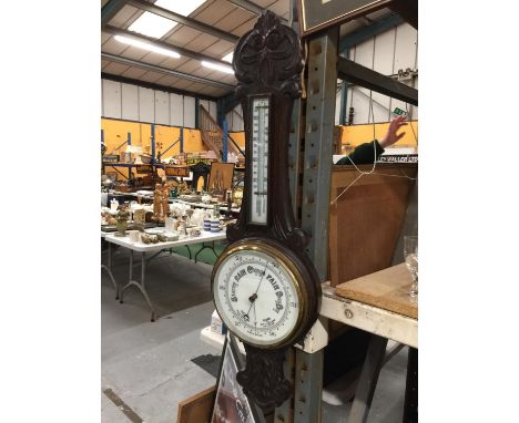 AN OAK CASED CARVED BAROMETER LENGTH 84CM 