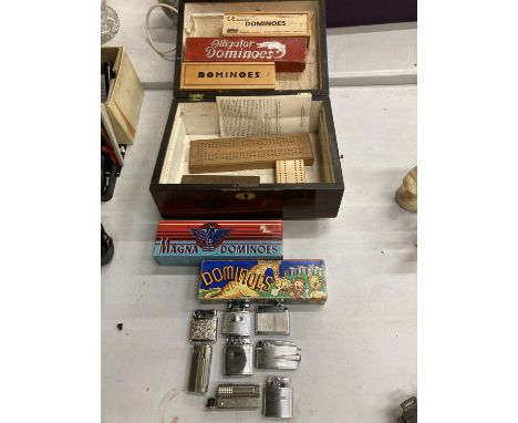 A MAHOGANY BOX CONTAINING VINTAGE DOMINOES AND CRIBBAGE BOARDS PLUS A QUANTITY OF VINTAGE LIGHTERS 