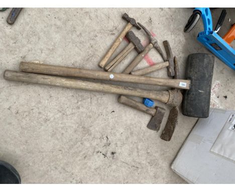 AN ASSORTMENT OF TOOLS TO INCLUDE A RUBBER HAMMER, AN AXE AND PICK AXE ETC 