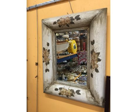 A LARGE BEVELLED GLASS MIRROR WITH WOODEN VINTAGE FRAME DECORATED WITH FLOWERS APPROX 76CM X 63CM 