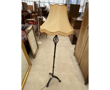 A BLACK CAST METAL STANDARD LAMP WITH SHADE 