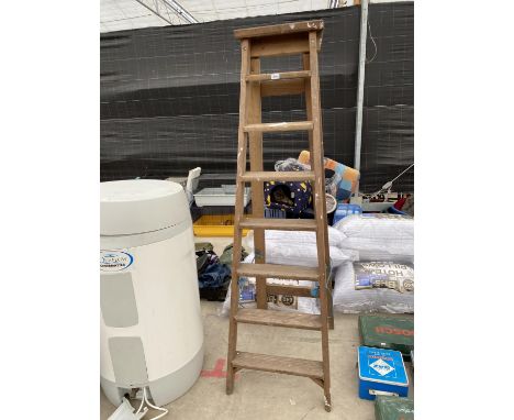 A VINTAGE SEVEN RUNG WOODEN STEP LADDER 