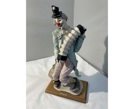 A GIUSEPPE ARMANI CLOWN PLAYING AN ACCORDIAN FIGURE 