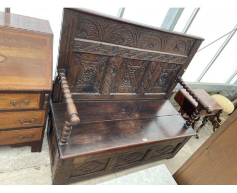 AN OAK GEORGIAN AND LATER SETTLE WITH PROFUSELY CARVED BACK AND BASE PANELS, WITH BOBBIN TURNED ARMS AND SUPPORTS, 51" WIDE 