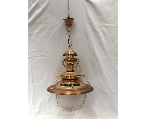 AN UNUSUAL BRASS AND COPPER PENDANT LIGHT WITH DOMED GLASS SHADE, SHIPS WHEEL DESIGN AND CHAINS 