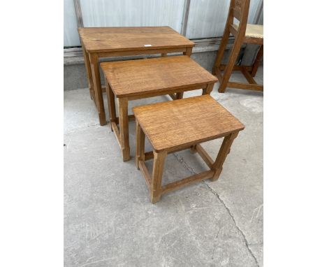 A MID 20TH CENTURY ROBERT 'MOUSEMAN' THOMPSON NEST OF THREE OAK TABLES ON OCTAGONAL LEGS, WITH ADZED TOPS - LOTS 2001 TO 2006