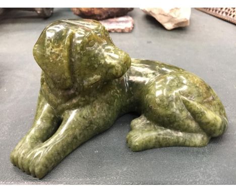 A JADE FIGURE OF A DOG LYING DOWN HEIGHT 8CM, LENGTH 15CM 